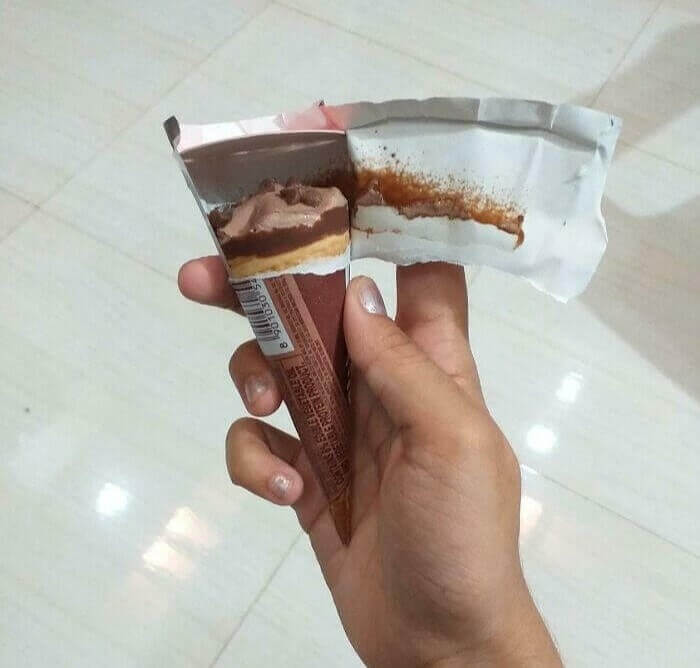 A picture containing food, person, hand, snack food Description automatically generated